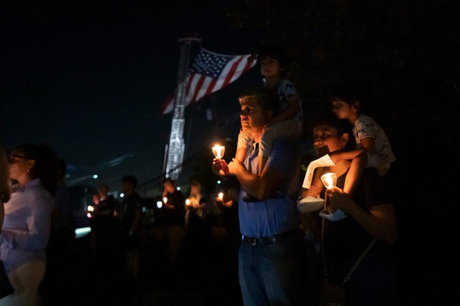 Audience members hold candles while listening to the names of Morris County residents who died in the Sept. 11 attacks.