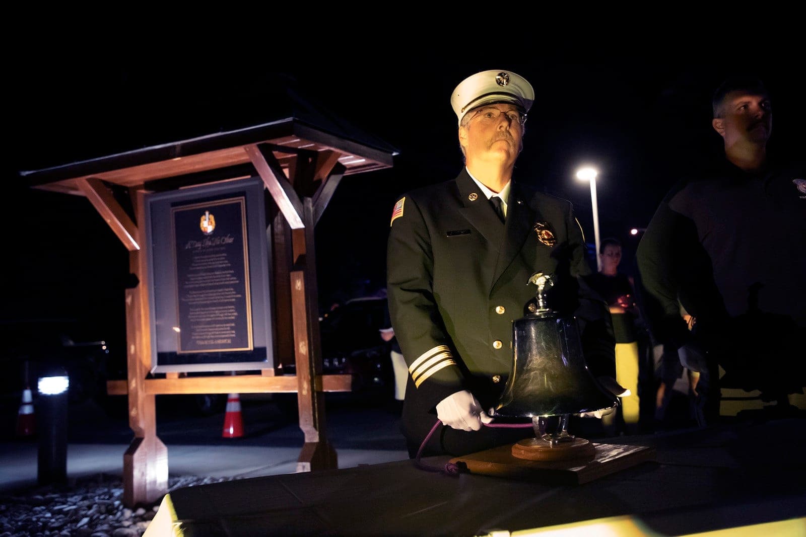 Retired Morris County Fire Marshal James Davidson rings a bell as the names of residents who died are read.